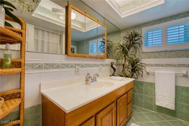 bathroom featuring tile walls, vanity, tile patterned floors, and a raised ceiling