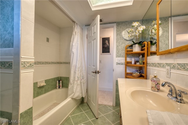 bathroom featuring vanity, tile walls, tile patterned flooring, and shower / bath combo with shower curtain