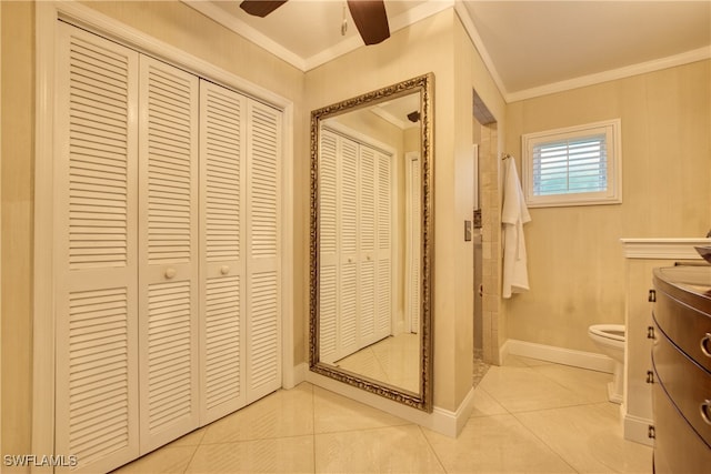 bathroom with a shower, toilet, and ornamental molding