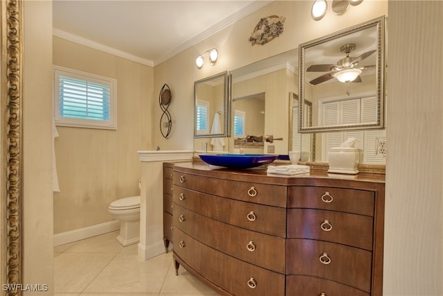 bathroom with ornamental molding, vanity, a healthy amount of sunlight, and toilet