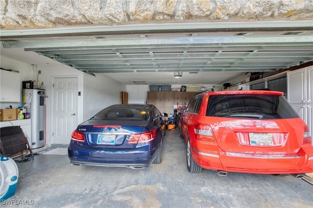 garage featuring a garage door opener, a carport, and electric water heater