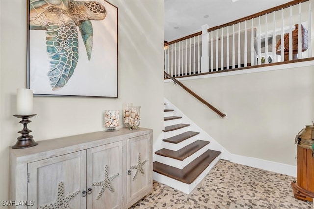 stairway featuring baseboards