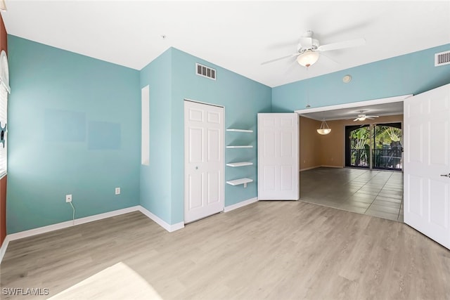 unfurnished bedroom with a closet, light wood-type flooring, and ceiling fan