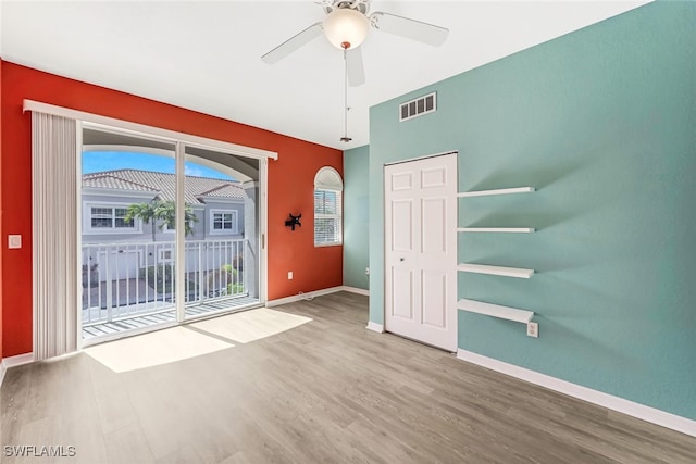 empty room featuring wood-type flooring and ceiling fan