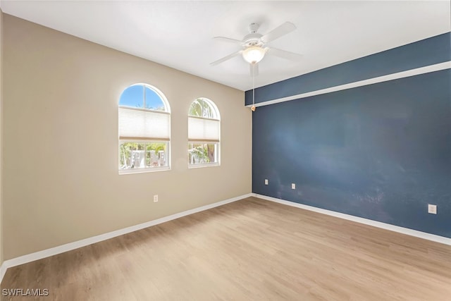 empty room featuring ceiling fan and light hardwood / wood-style flooring