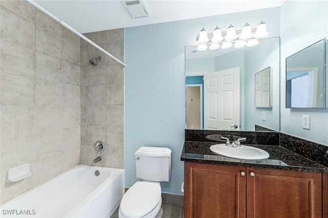 full bathroom featuring vanity, toilet, and tiled shower / bath combo