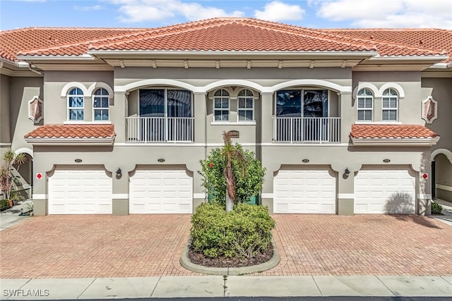 mediterranean / spanish-style home with a garage