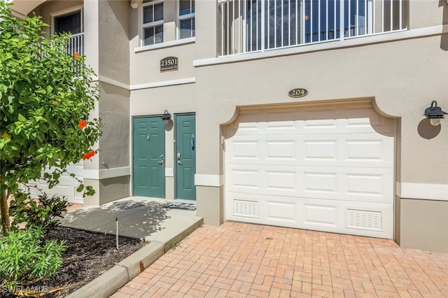 doorway to property featuring a garage