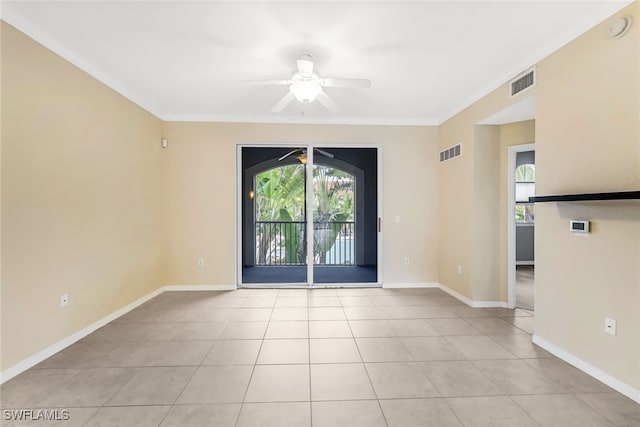 unfurnished room featuring ceiling fan, light tile patterned floors, and crown molding