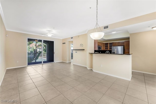 unfurnished living room featuring ceiling fan, light tile patterned floors, and ornamental molding