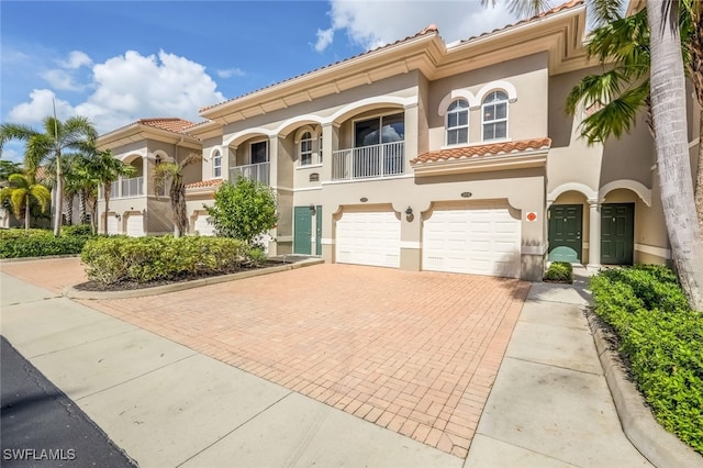 mediterranean / spanish-style home with a garage