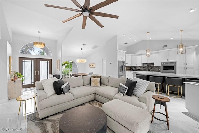 living room with french doors, high vaulted ceiling, and a chandelier