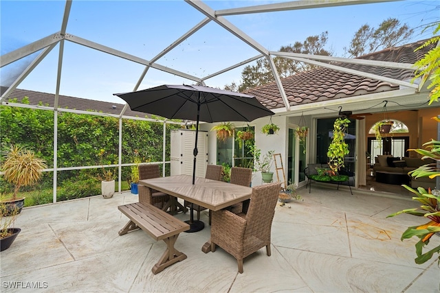 view of patio with ceiling fan and a lanai