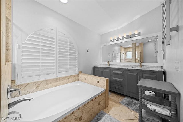 bathroom featuring plus walk in shower, vanity, and tile patterned flooring