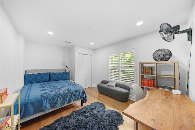 bedroom featuring wood-type flooring and a closet