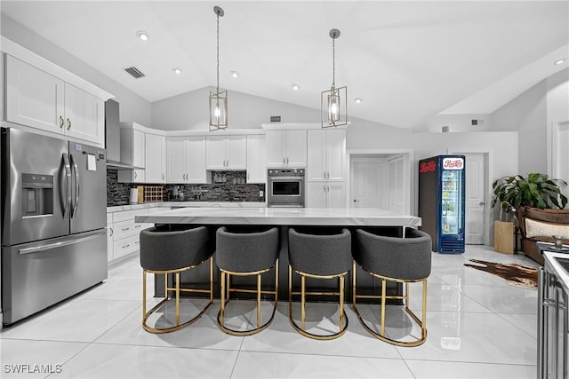 kitchen featuring stainless steel appliances, a center island, white cabinets, wall chimney range hood, and pendant lighting