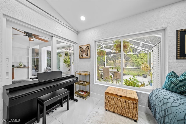 sitting room featuring vaulted ceiling, concrete flooring, and ceiling fan