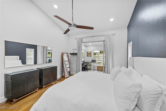 bedroom featuring hardwood / wood-style flooring, high vaulted ceiling, and ceiling fan