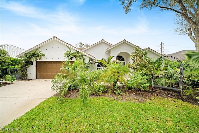 view of front of house with a garage and a front yard