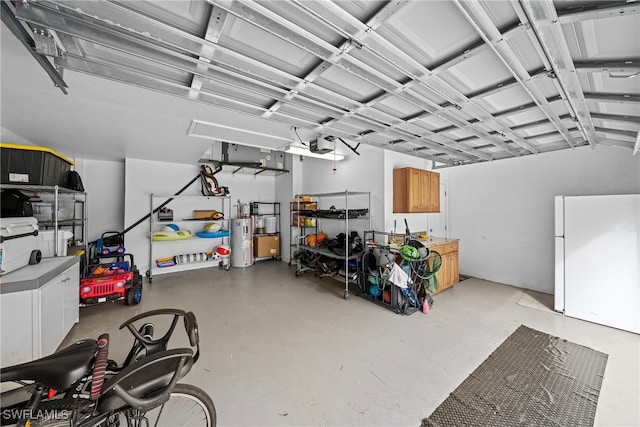 garage with a garage door opener, electric water heater, and white refrigerator