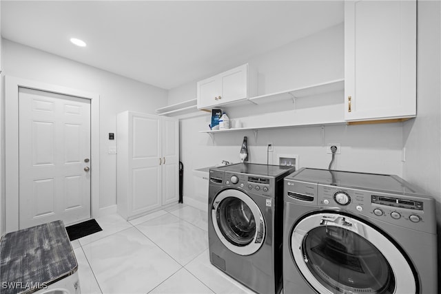 washroom featuring cabinets and separate washer and dryer