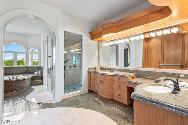 bathroom featuring vanity and plus walk in shower