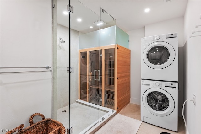 clothes washing area featuring stacked washer / dryer