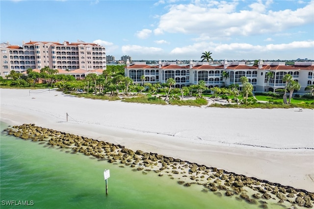 birds eye view of property featuring a beach view and a water view