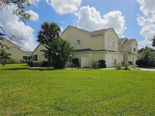 view of front of house with a front yard and a garage