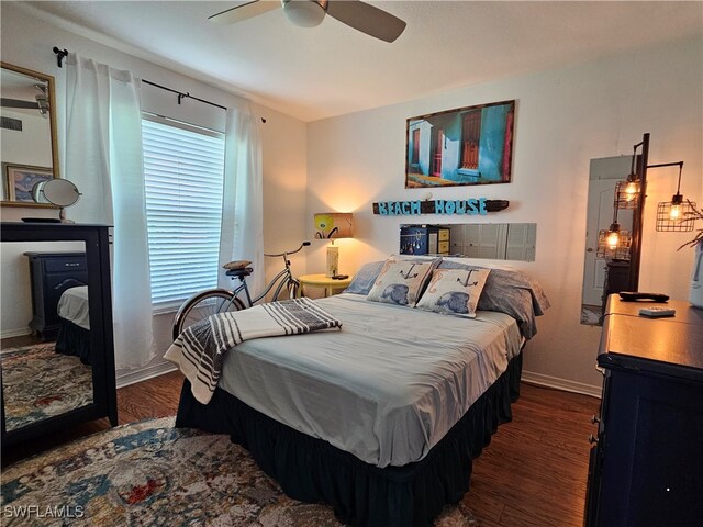 bedroom with dark wood-type flooring and ceiling fan