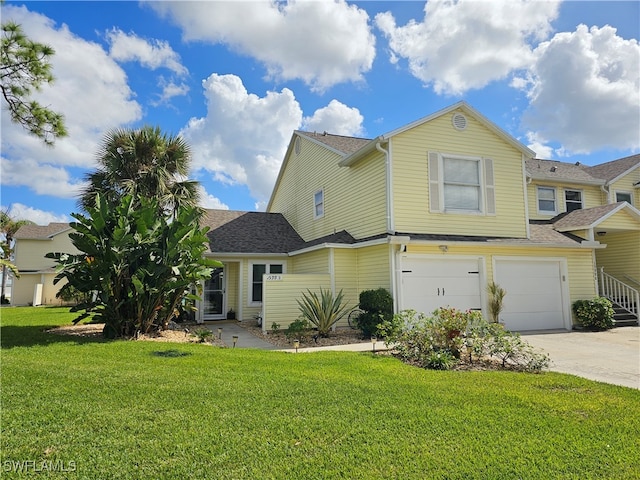 view of front of house with a garage and a front lawn