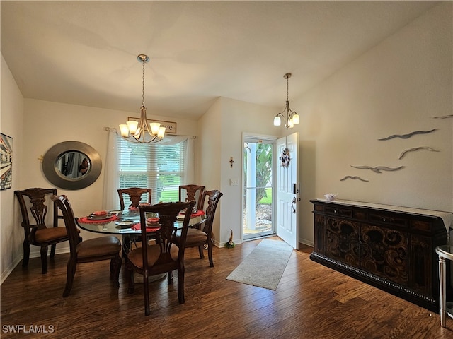 dining space with a chandelier and dark hardwood / wood-style floors