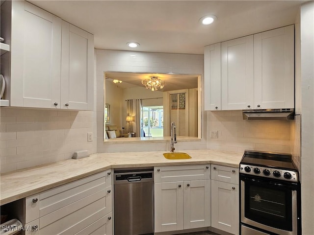 kitchen featuring appliances with stainless steel finishes, white cabinetry, a sink, and under cabinet range hood