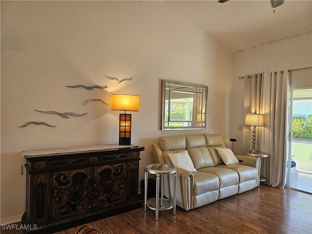 living area featuring lofted ceiling and dark wood finished floors