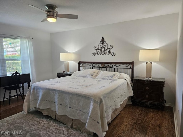 bedroom featuring a ceiling fan, baseboards, and wood finished floors