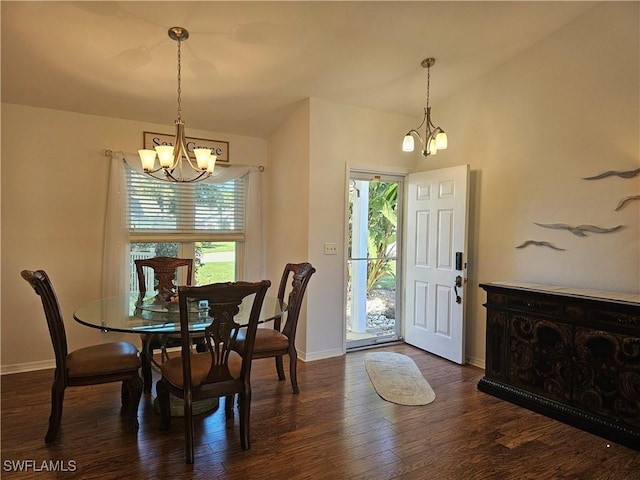 dining area featuring vaulted ceiling, baseboards, dark wood finished floors, and a notable chandelier