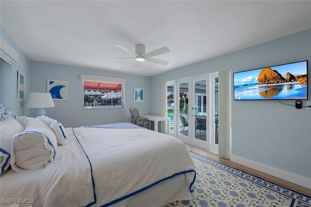 bedroom with access to exterior, french doors, wood-type flooring, and ceiling fan