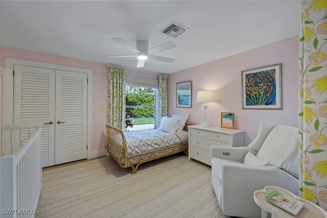 carpeted bedroom featuring ceiling fan and a closet