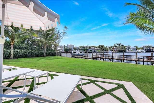 view of yard featuring a water view and a patio area