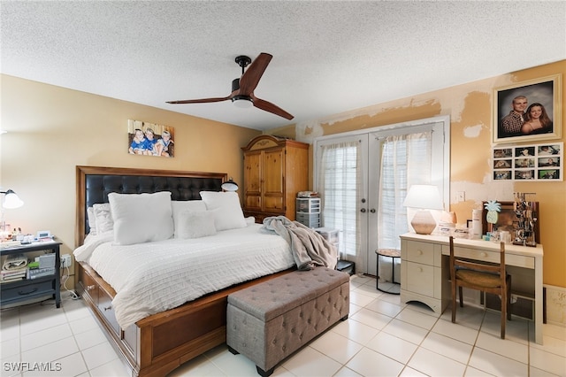 bedroom with french doors, built in desk, a textured ceiling, light tile patterned floors, and ceiling fan