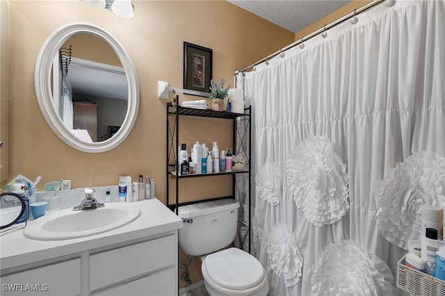 bathroom featuring vanity, walk in shower, a textured ceiling, and toilet