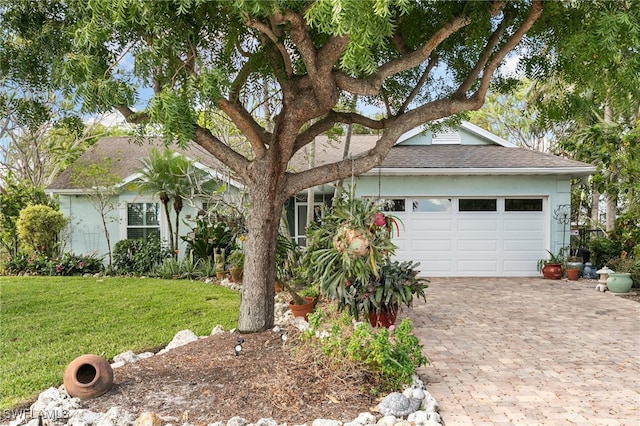 ranch-style house featuring a garage and a front yard