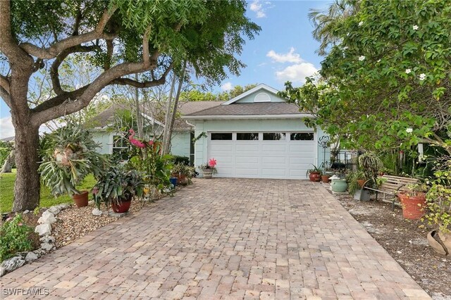 120 Sand Hill St, Marco Island, FL 34145 - ranch-style home with decorative driveway and a garage