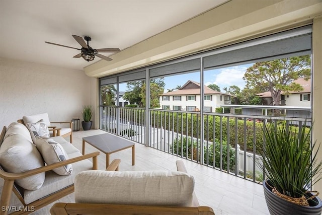 sunroom featuring ceiling fan and a wealth of natural light