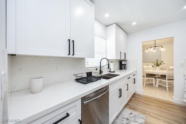 4126 Belair Ln Unit C6, Naples, FL 34103 - kitchen featuring dishwasher, a sink, white cabinetry, tasteful backsplash, and light wood-style flooring