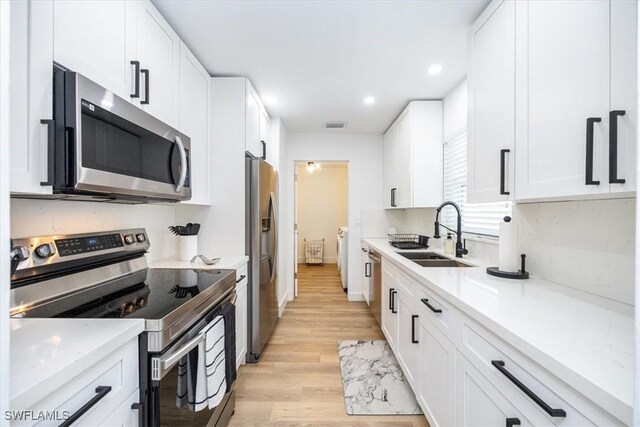 kitchen featuring sink, white cabinets, and stainless steel appliances