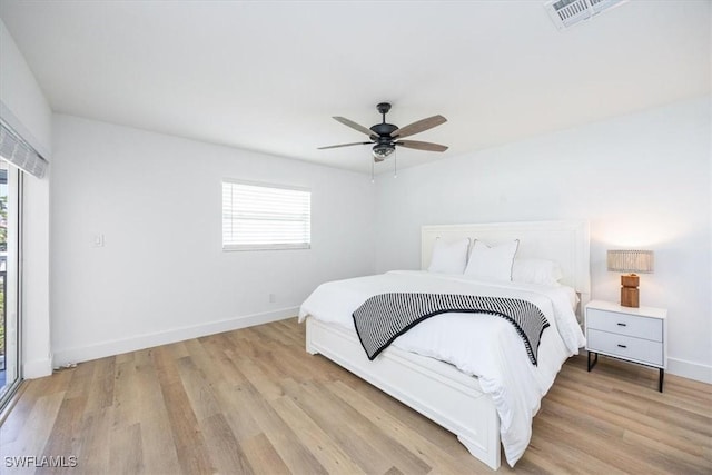 4126 Belair Ln Unit C6, Naples, FL 34103 - bedroom with multiple windows, wood finished floors, and baseboards