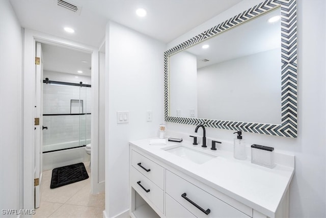 full bathroom featuring tile patterned flooring, toilet, vanity, and shower / bath combination with glass door