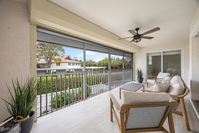 sunroom featuring ceiling fan