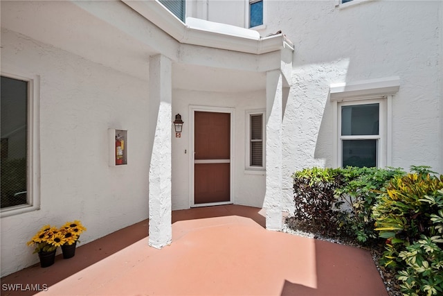 property entrance featuring a patio area